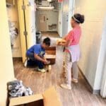 Two people working together on a home improvement task indoors.