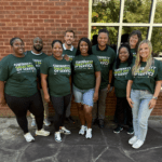 Group wearing matching green service shirts.